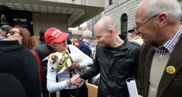 Paul Murphy greeting a supporter at a protest over the policing of the anti-water charges movement at the Central Bank in Dublin on Saturday. Photograph: Dara Mac Dónaill / The Irish Times