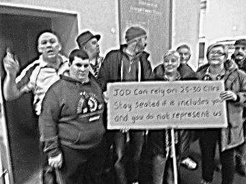 Protestors inside the County Chamber voice their sentiments about Councillor John O’Donnell, corruption and cronyism within and outside Donegal County Council.