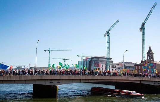 Protest: March against water charges crosses the Matt Talbot Bridge in Dublin yesterday. Photo : Colin O'Riordan