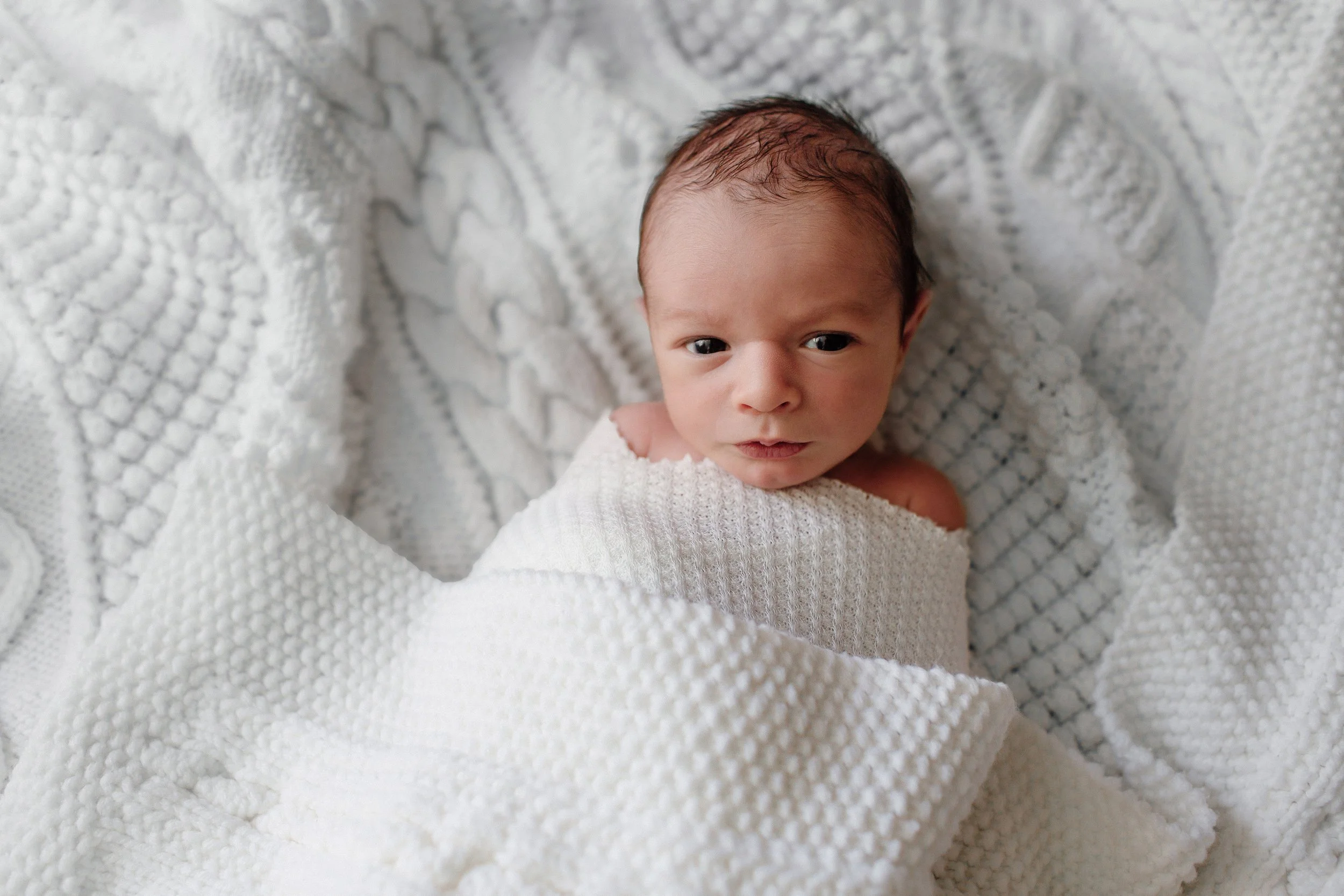 Denver newborn infant lifestyle photos baby laying on textured blanket solo