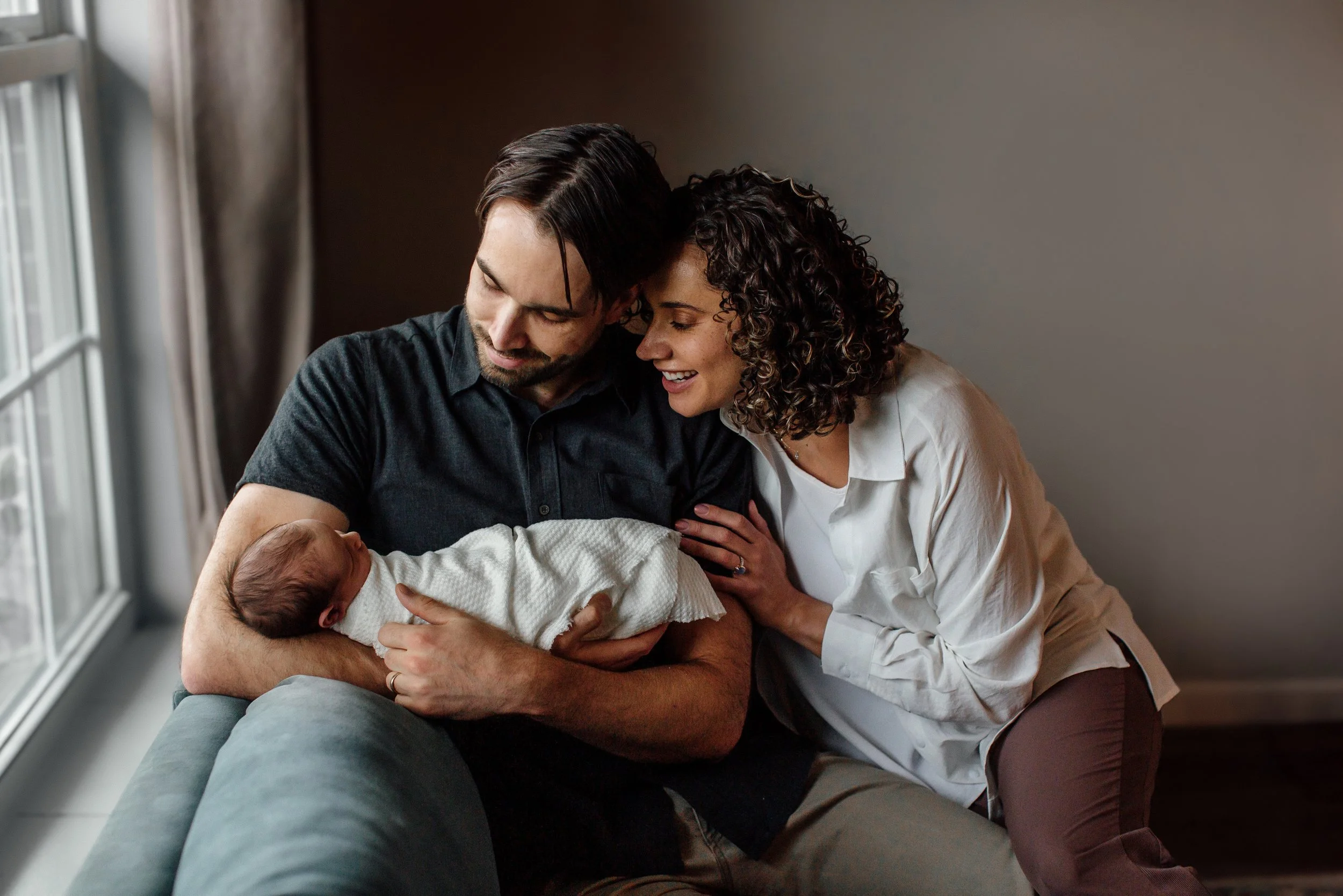 Intimate family newborn session with parents holding baby in denver lifestyle newborn session