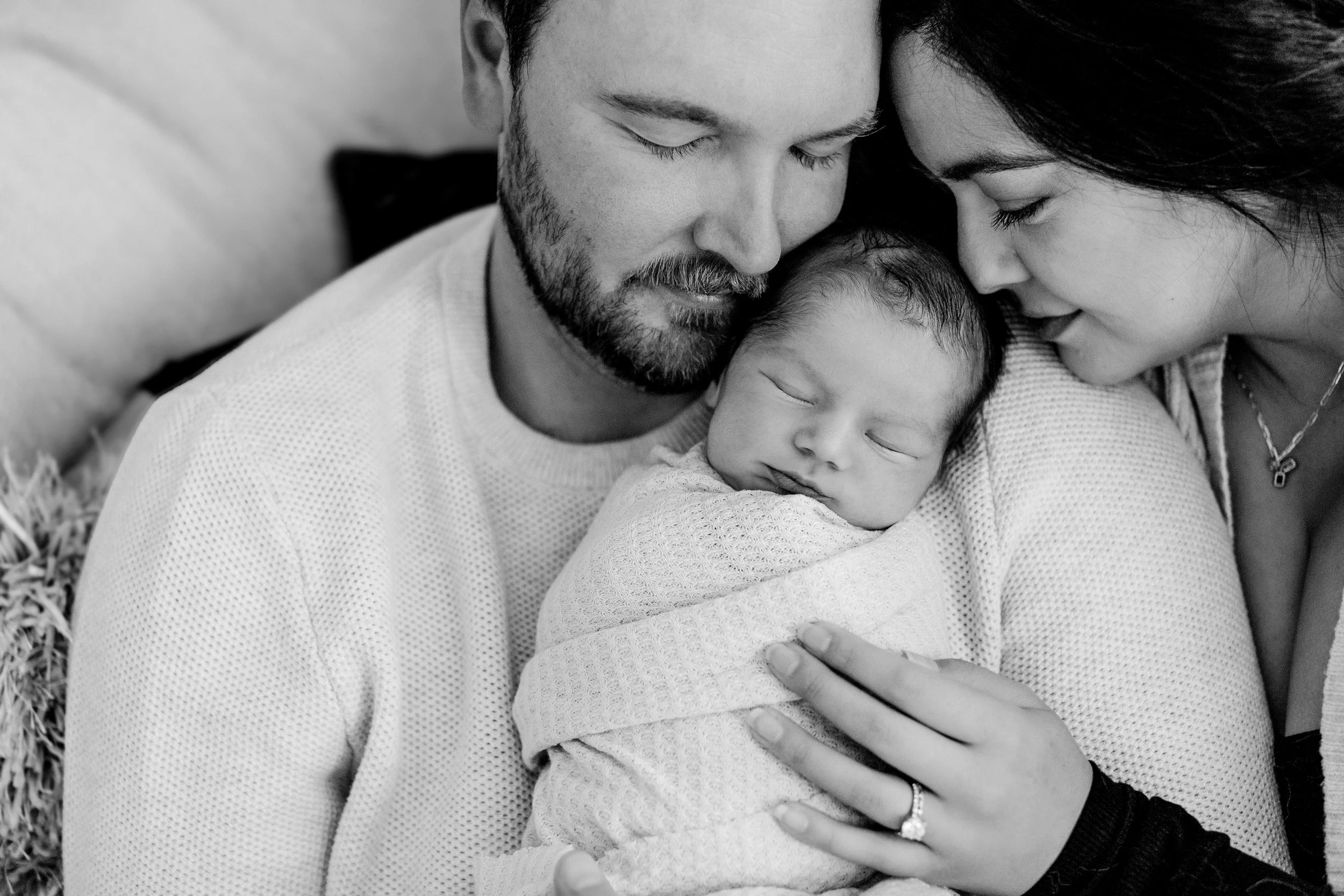 parents snuggling baby for denver newborn lifestyle session in home with infant
