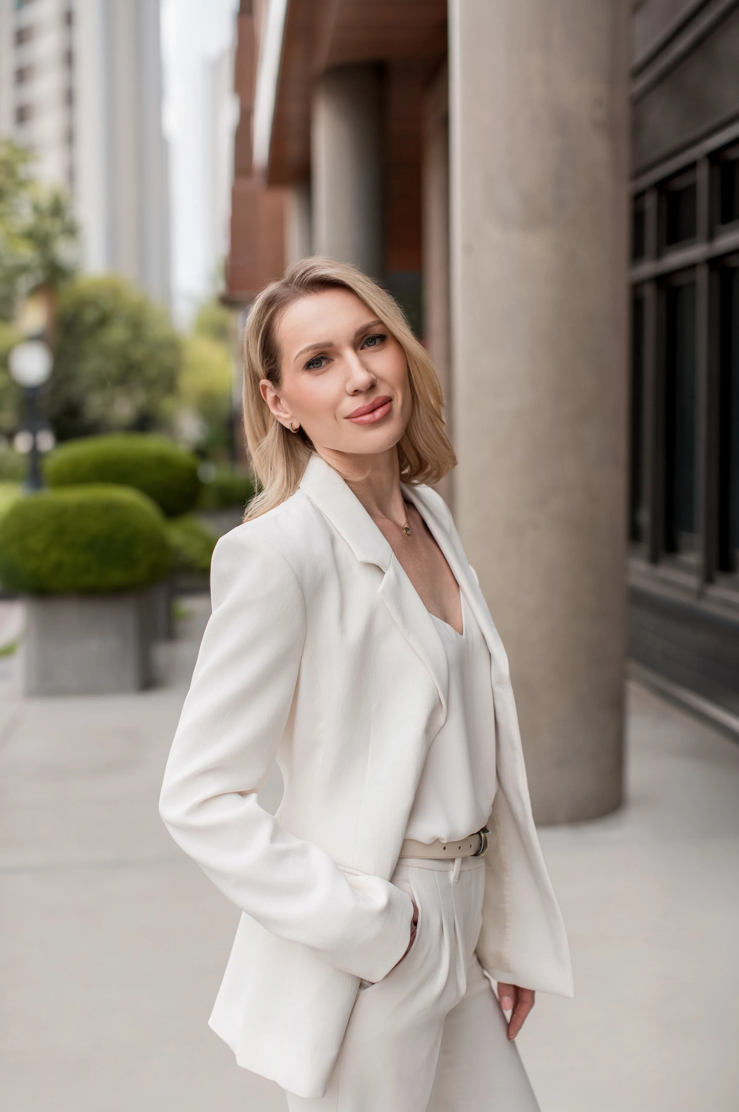 Denver Headshots, headshots of real estate agent in Denver in white suit looking chic