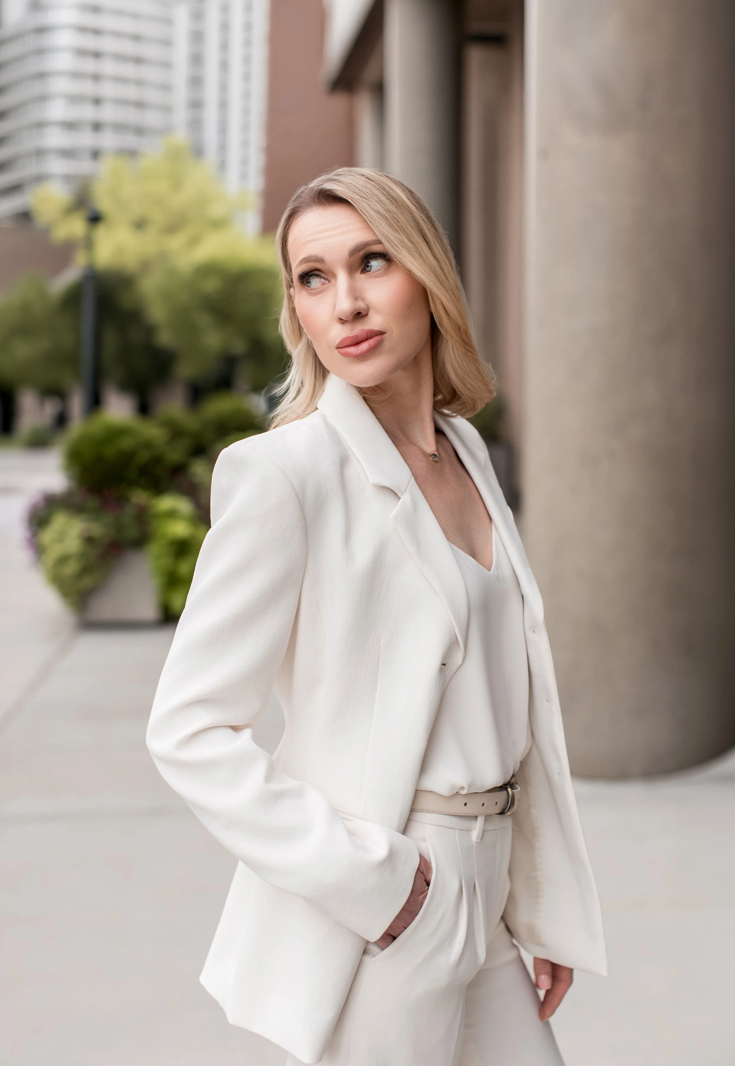 Denver Headshots, headshots of real estate agent in Denver in white suit looking chic