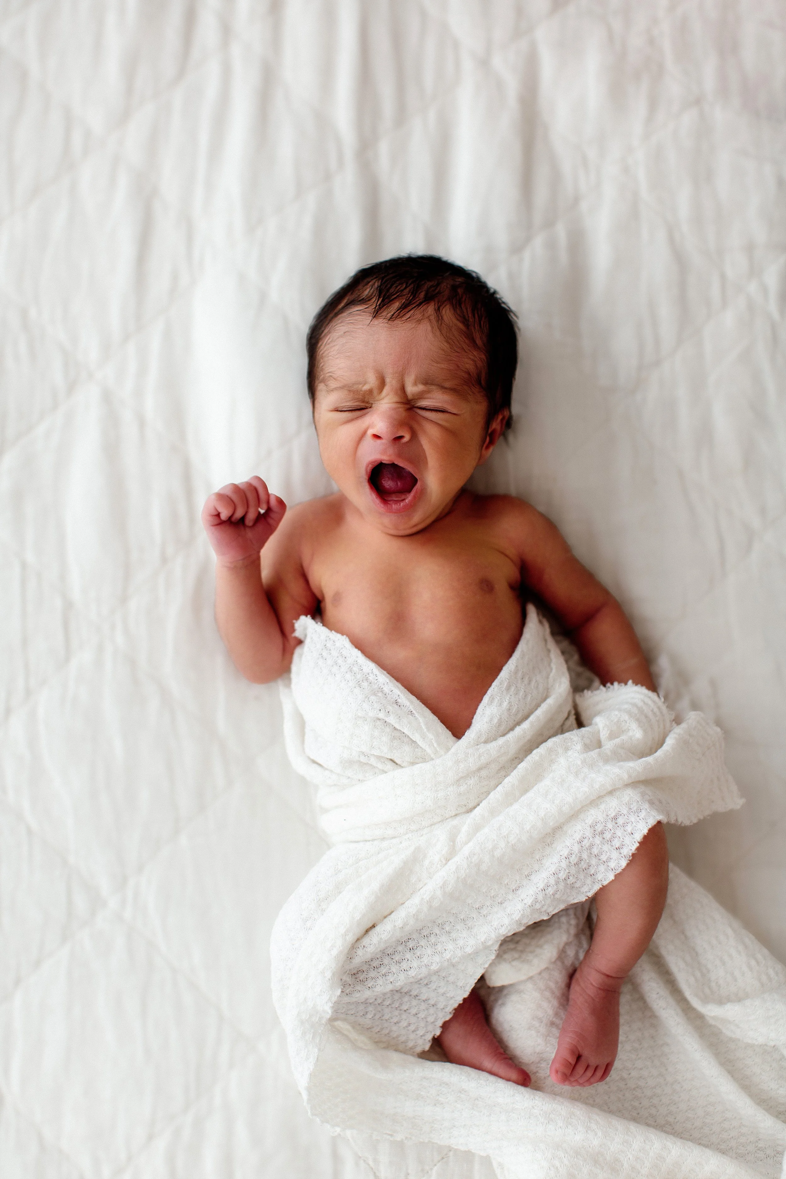 Denver Newborn Studio Photo Session solo baby swaddled and yawing
