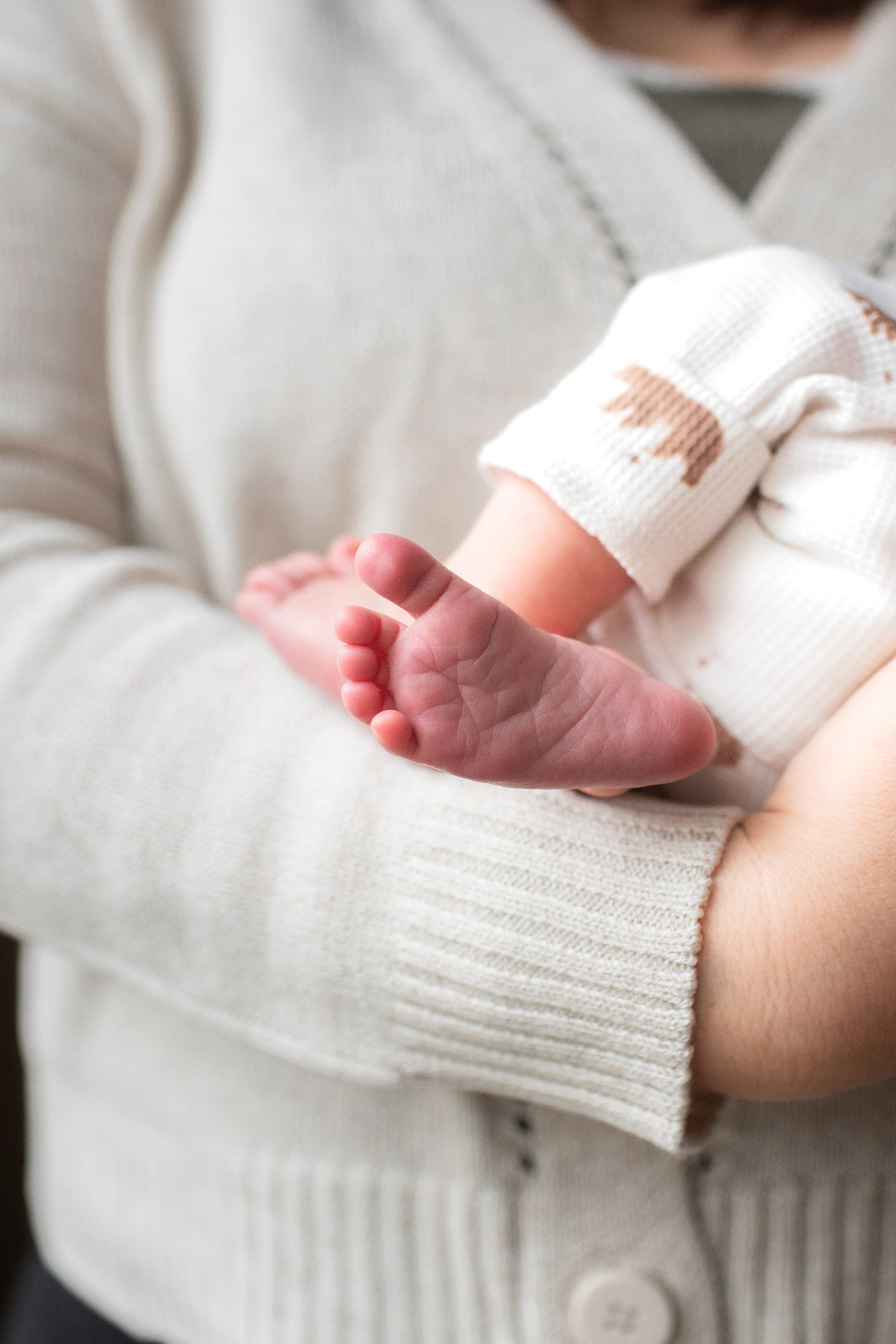 Denver Newborn Lifestyle photos in home with infant and parents detail foot shot of baby