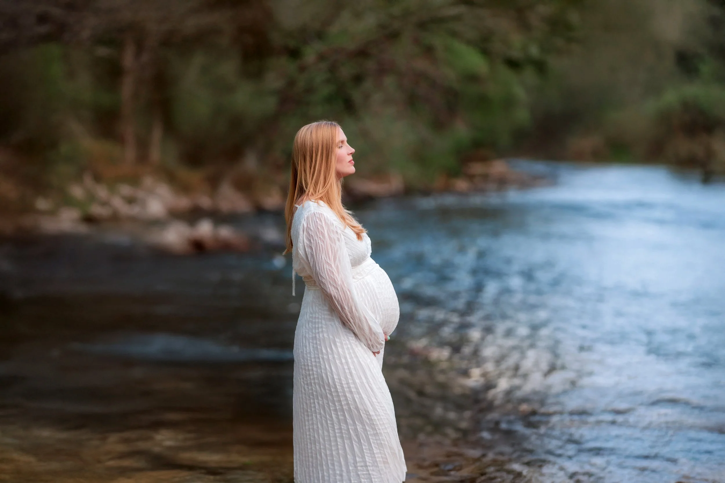 Pregnant mother standing in a creek during a natural light outdoor maternity session photographed by Denver maternity photographer Jessica Jo Photo.