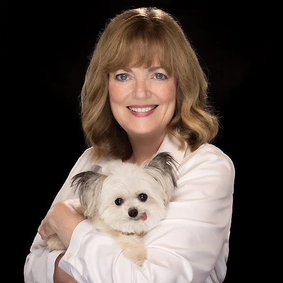 Virginia with Norbert, 3-lb. registered therapy dog who gives world's best high-fives