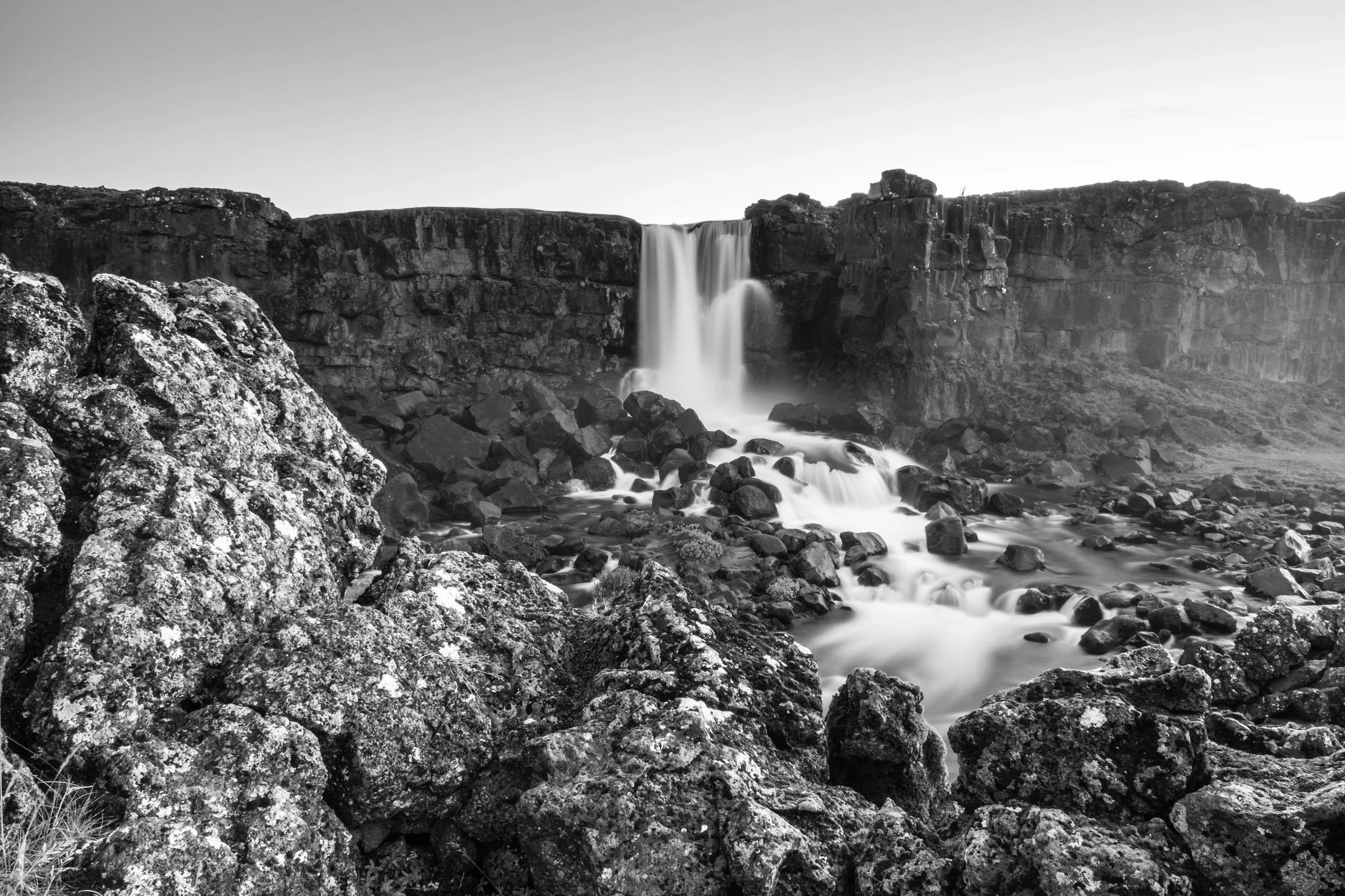 A few steps back, something more unique which shows the beauty and texture of the landscape. I would choose the first as it shows the falls better but this works too in my opinion.