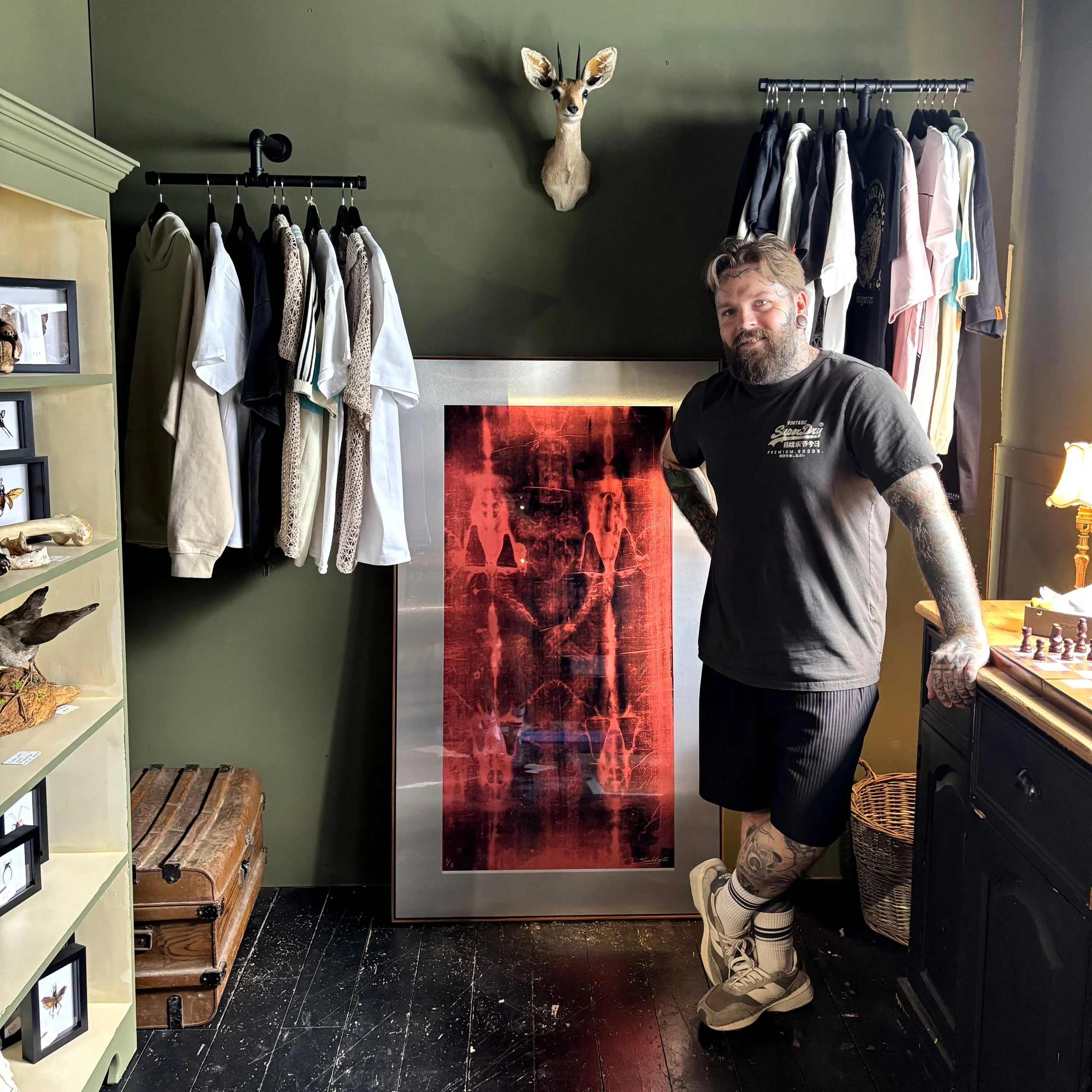 Louis Sidoli at Callum Parr Tattoo studio with "Resurrection" Turin Shroud artwork in aluminium