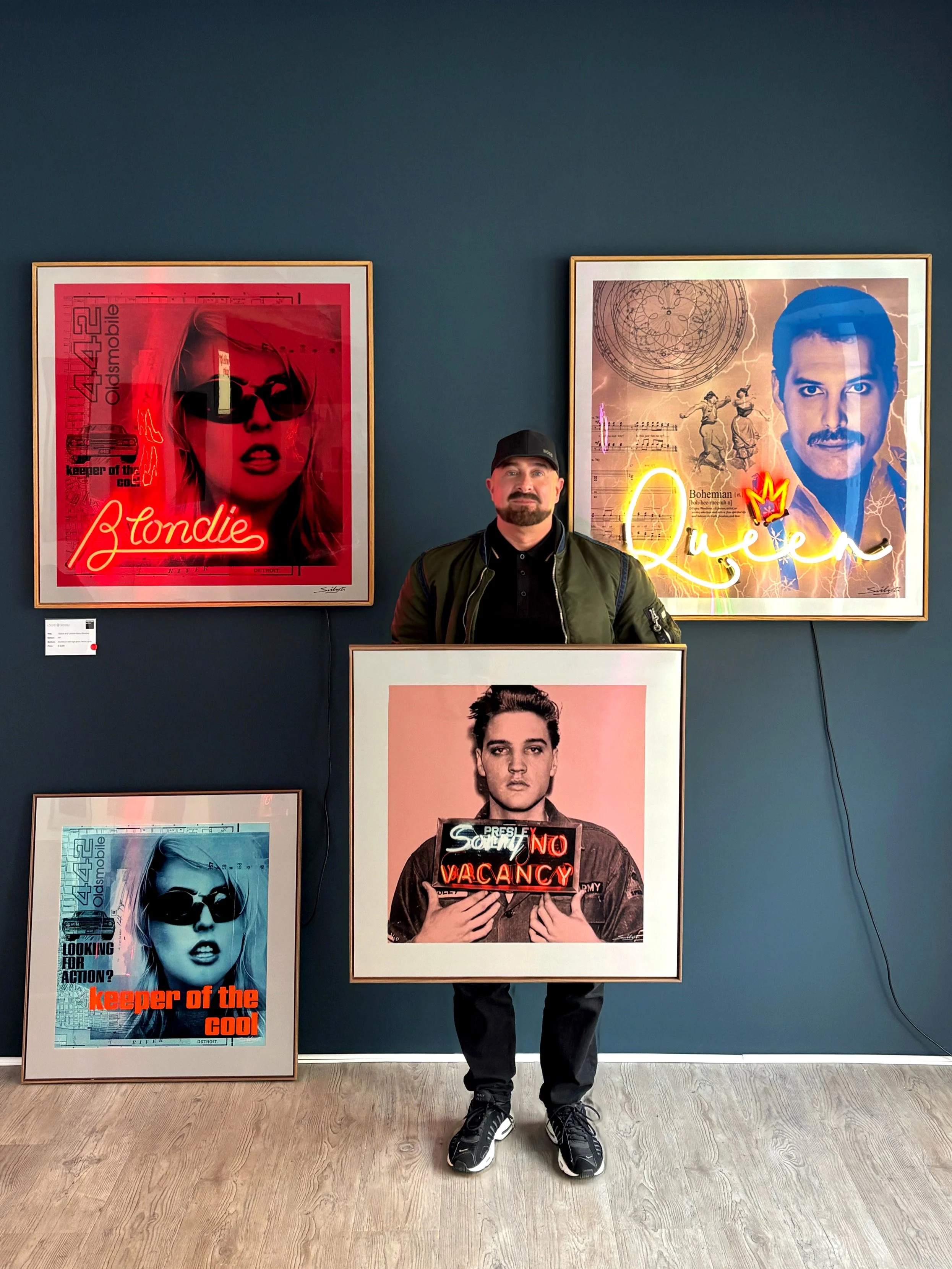artist Louis Sidoli with neon artwork at white light gallery