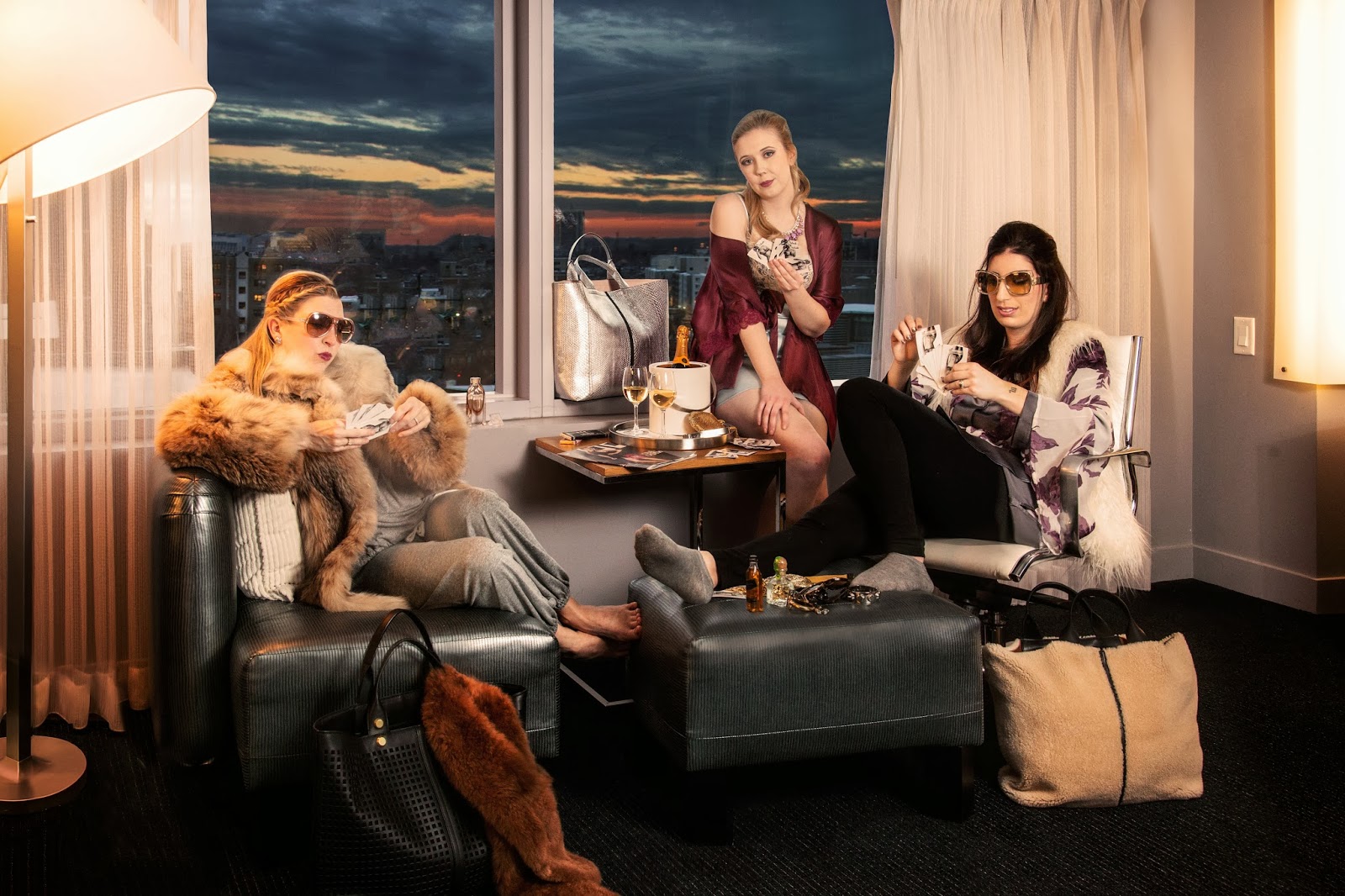 Look Three, "Poker Face": KRISTEN Eberyjay heather pant and slouchy tee, Forty Winks , fur coat + stole (on bag), Kristen's own.Sunglasses, $275 and Bionic Leather and Suede Track Tote , $1990 by Reed Krakoff at Saks Fifth Avenue Boston. KARA Metallic Python Track Tote in Silver $3990 , Reed Krakoff via Saks Fifth Avenue. Crimson silk robe, Intimacy. RENATA Bold Botanical Short Night Robe by Beautiful Bottoms at Forty Winks , Silk Sleepshirt, $157 at Intimacy . Fur Vest, H&M, Sunglasses, $275 and shearling tote $1490, Reed Krakoff via Saks Fifth Avenue.
