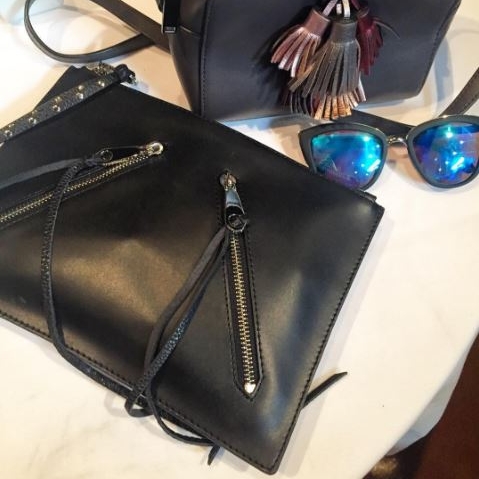 Rebecca Minkoff leather clutch; Quay Australia sunglasses.