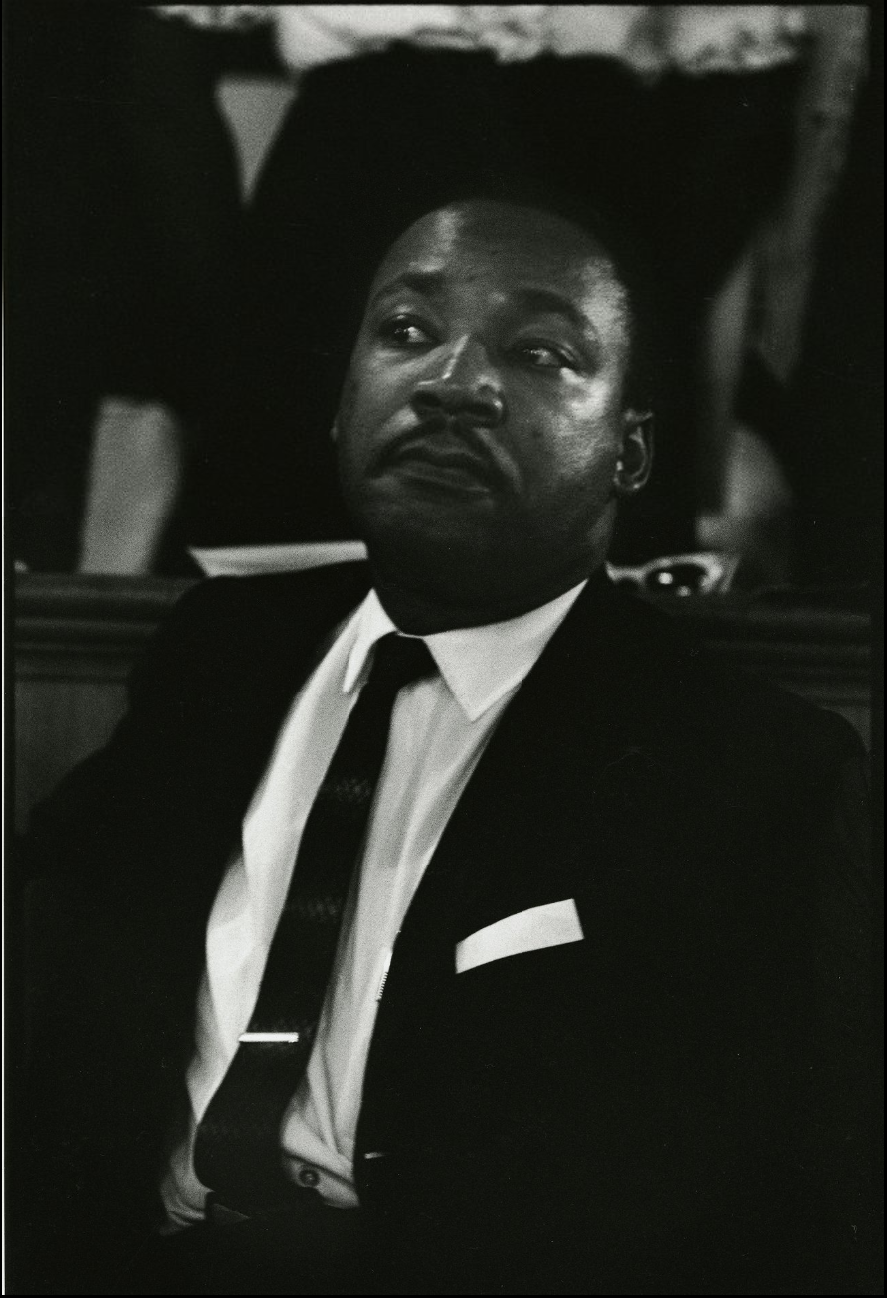 Dr. Martin Luther King, Jr., waiting to speak at the girls' funeral, Birmingham, AL, 1963