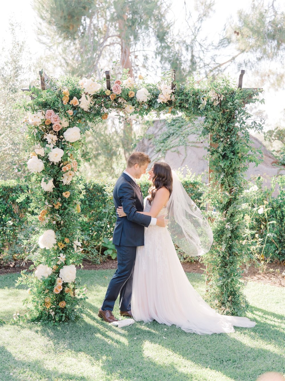 square ceremony arch trailing greenery.jpg