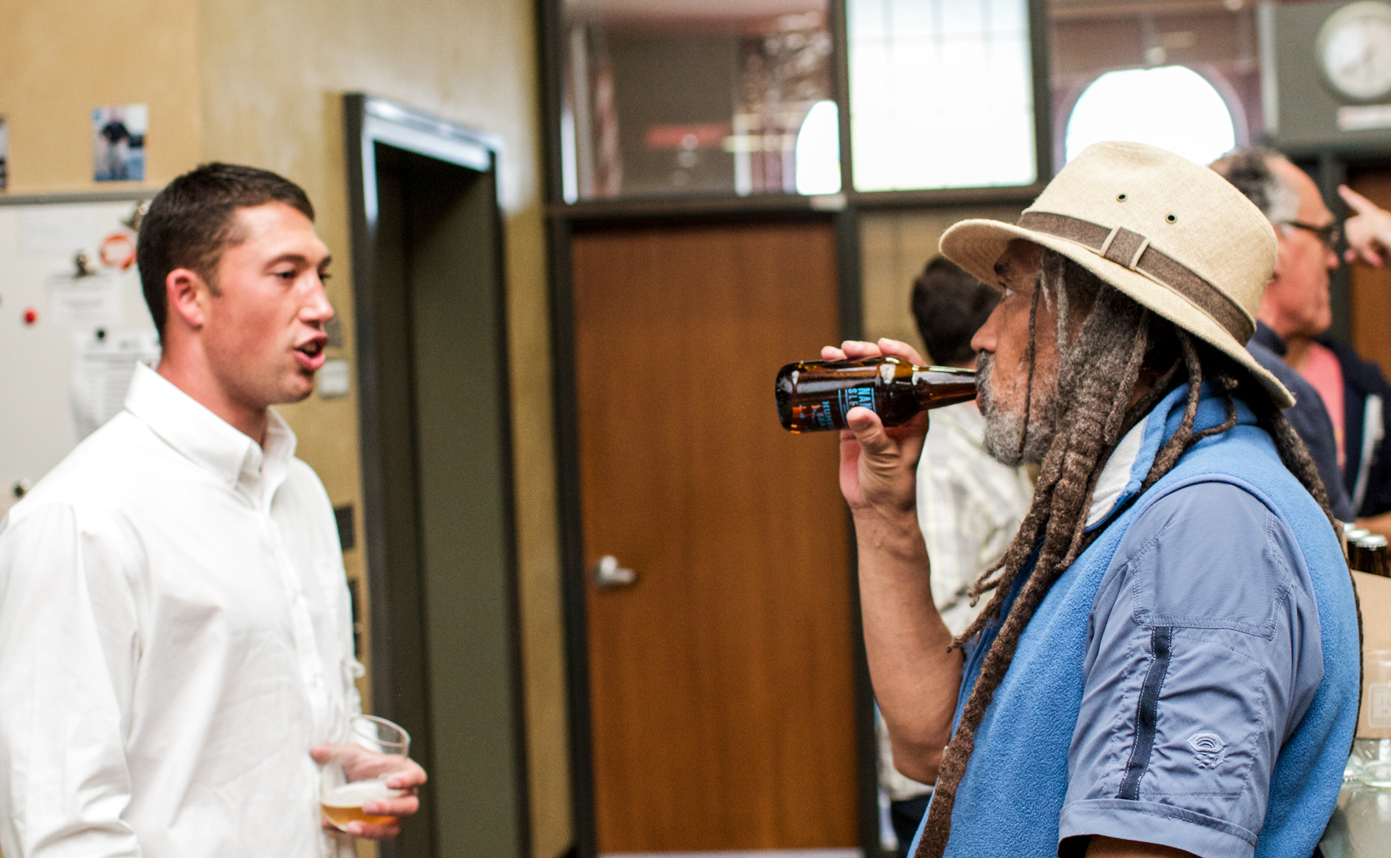 Taylor talking beer with a NextSpace community member.