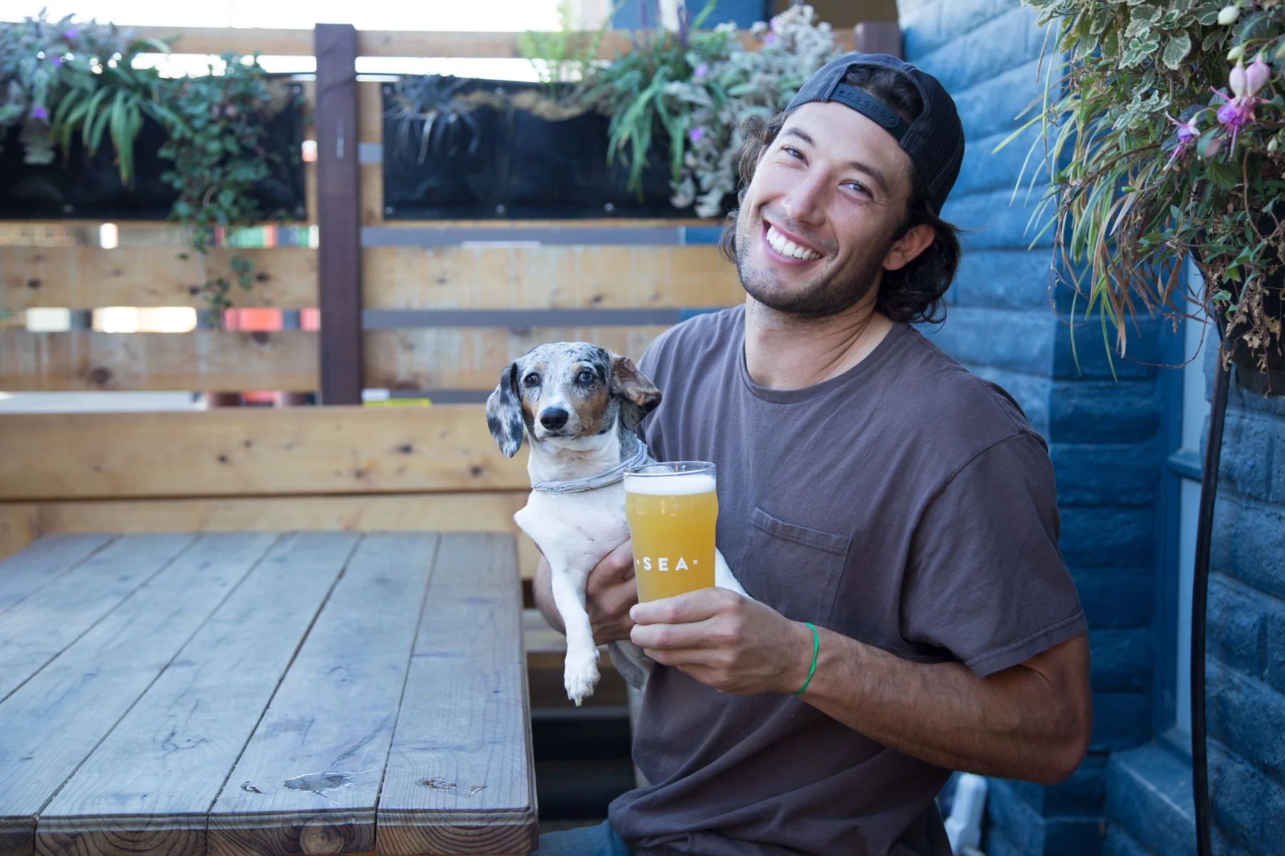 Cofounder Taylor West crushing a new Humble Sea nonic pint glass with Billie the dog.