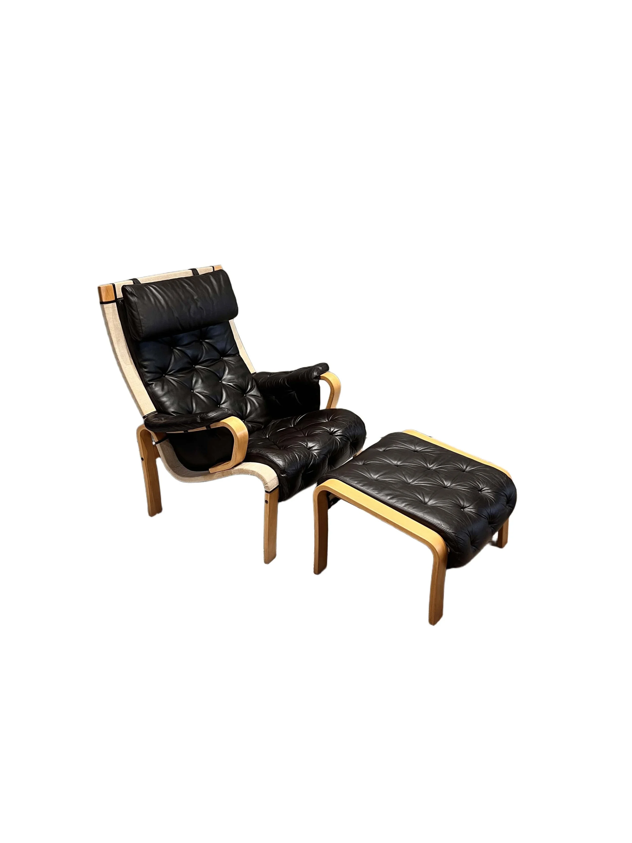nielaus-jeki-lounge-chair-and-footstool-black-leather.jpg