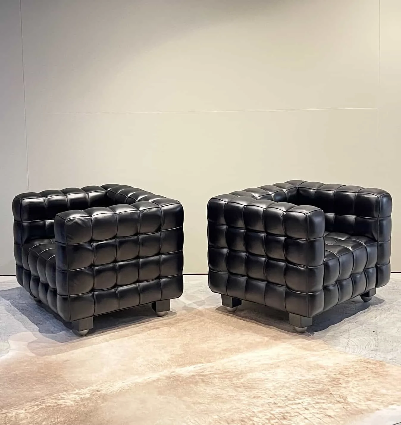 pair of mid century black leather club chairs.jpeg