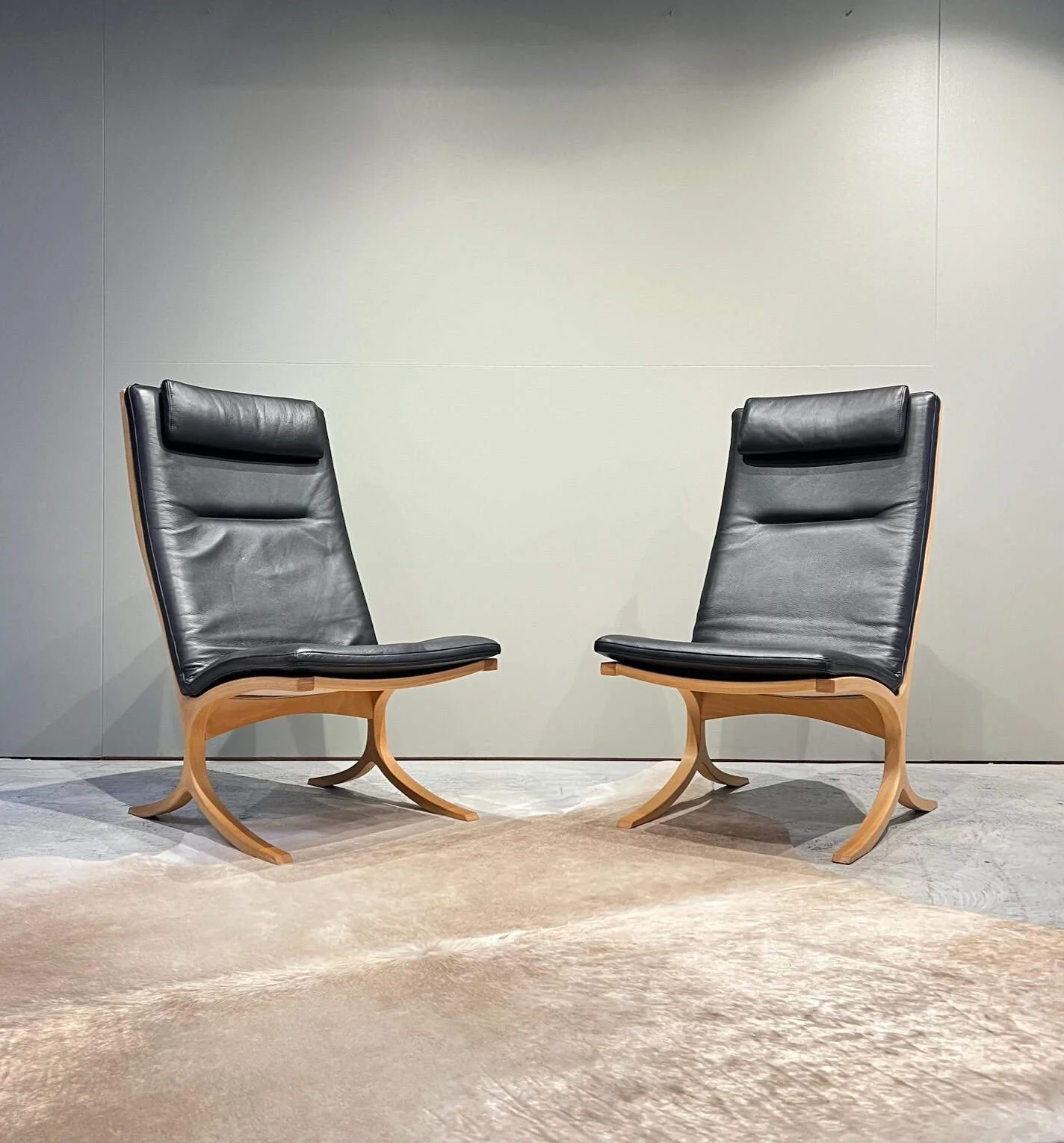 pair of black leather danish lounge chairs.jpeg