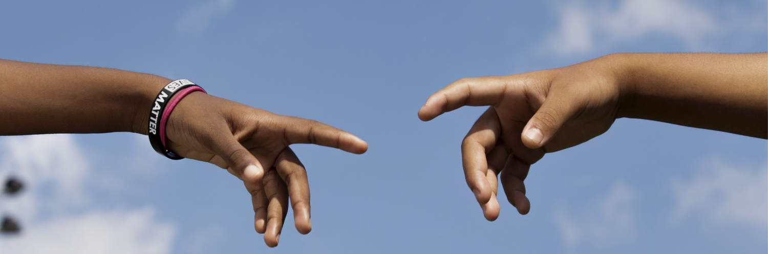 young people touching hands