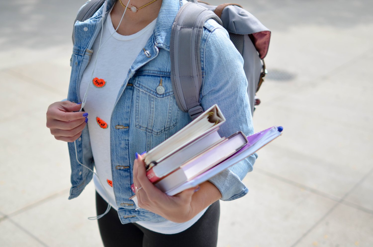 young person holding books