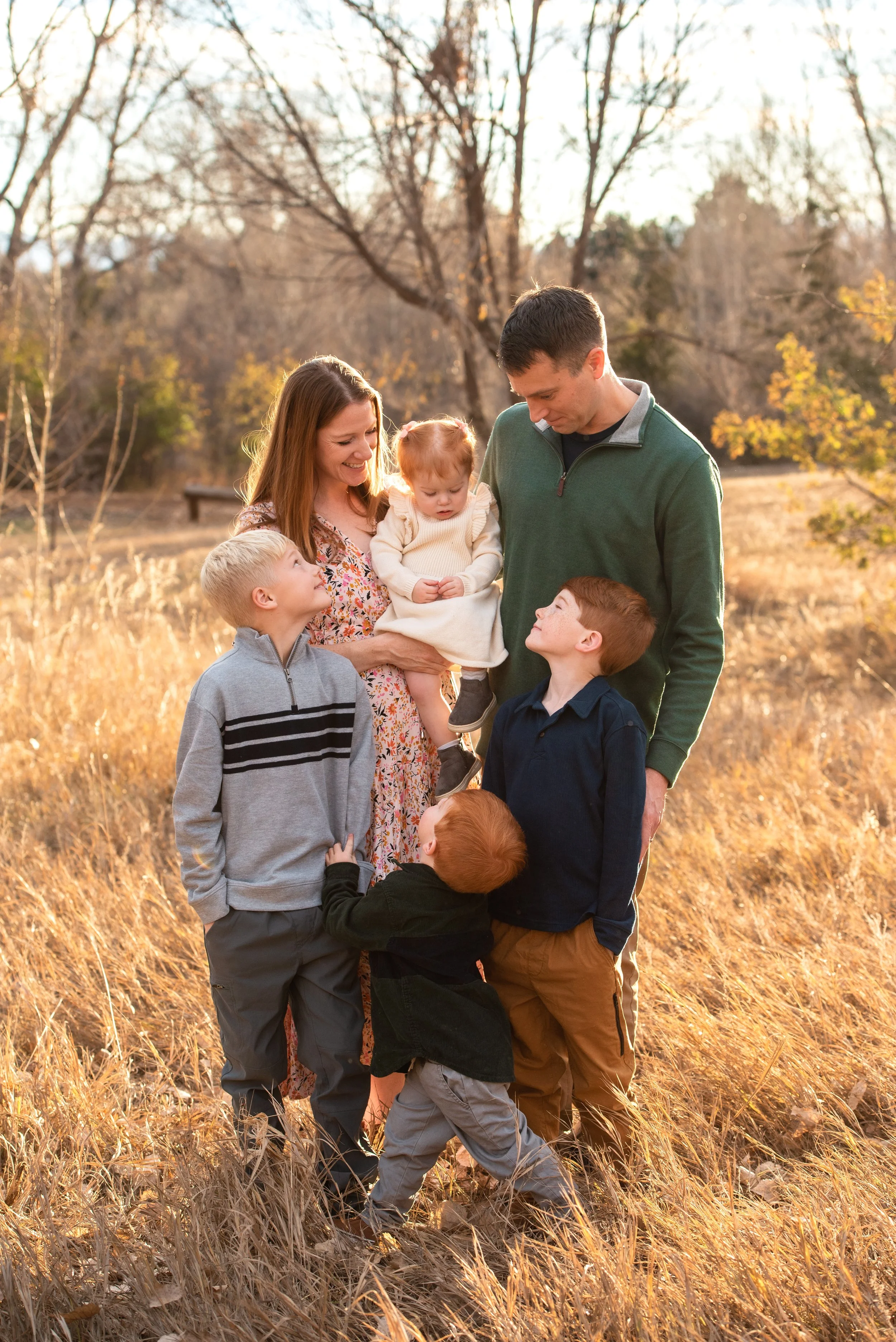 Red Head CHildren stand with parents in a Colorado open space for Family Photos