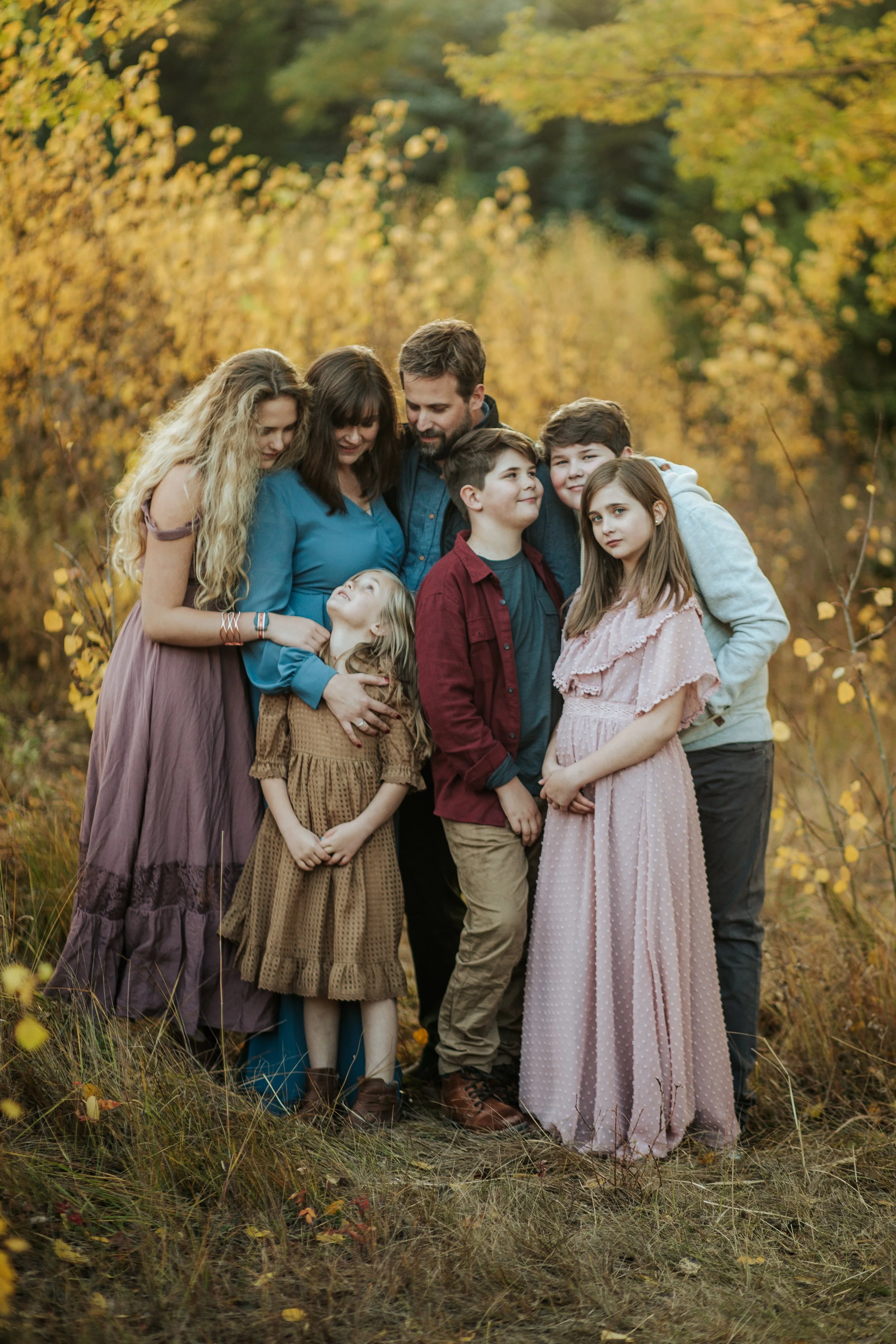 Best Denver Photographer poses with her family in Aspens in Evergreen Colorado