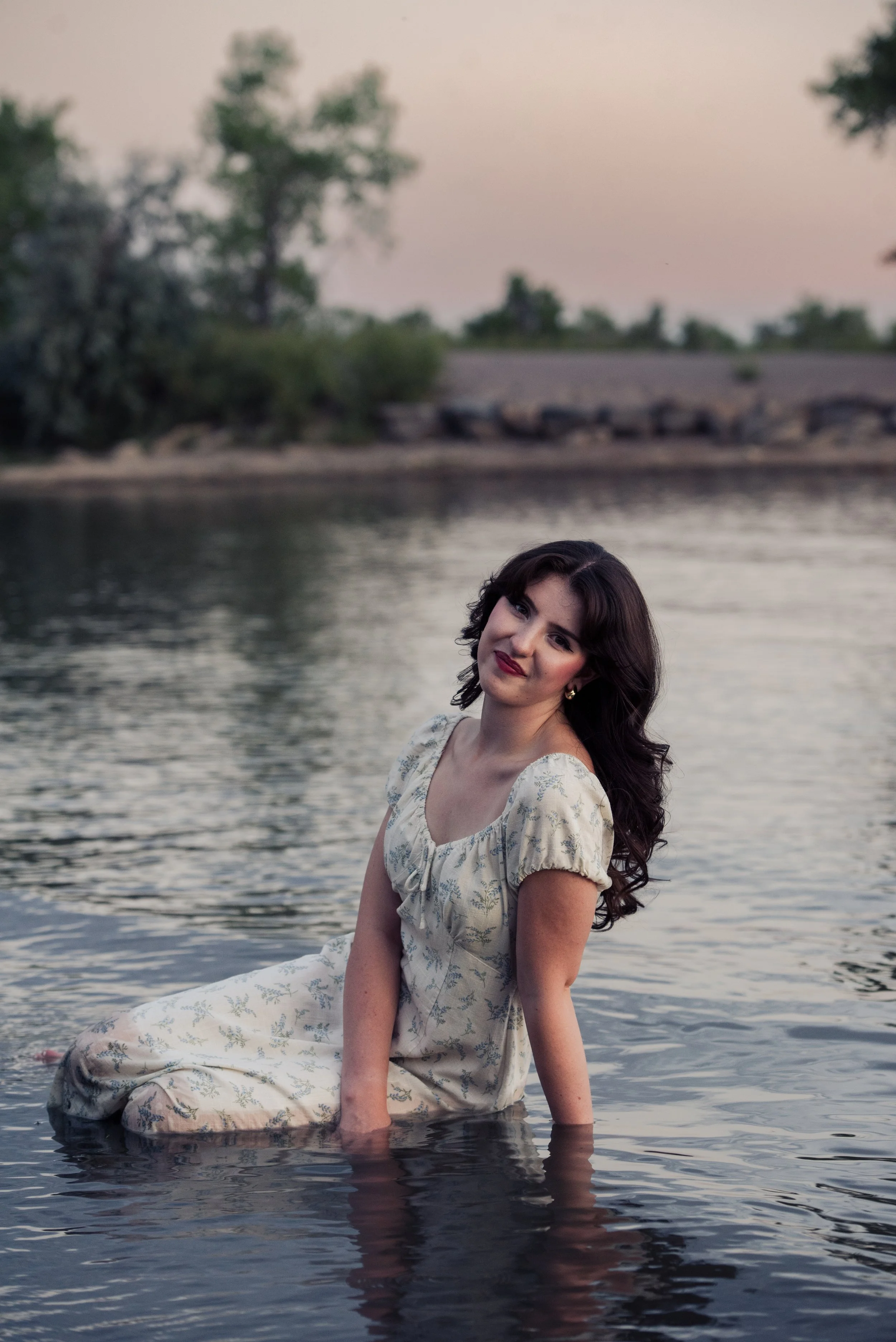 Senior girl poses in a lake at Cherry Creek Reservoir