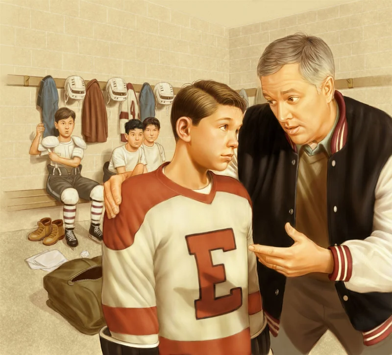 A coach speaking to a young hockey player in a locker room with other players sitting on a bench in the background.