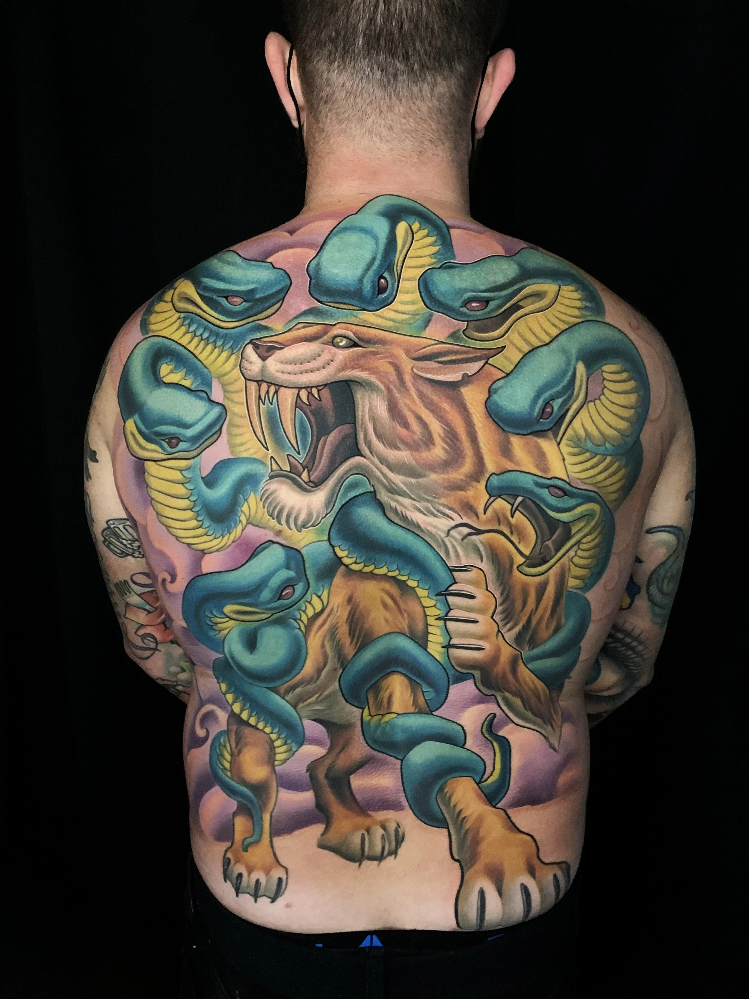 saber tooth cat and snake back piece tattoo