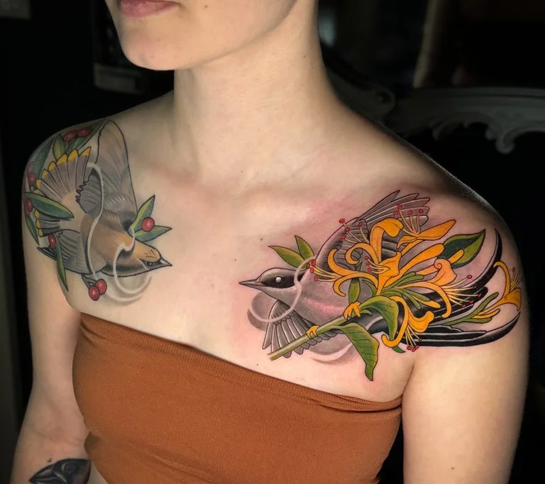 Mirrored Bird Tattoos on a Woman's Shoulders