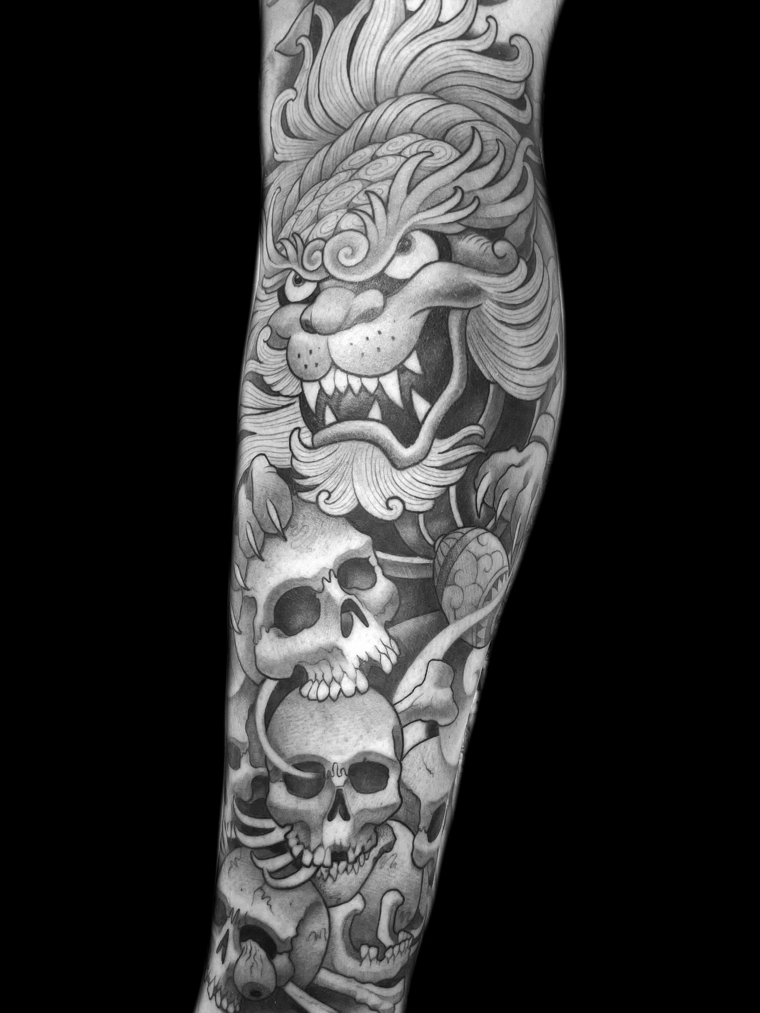 Fu Dog and Stack of Skulls Tattoo