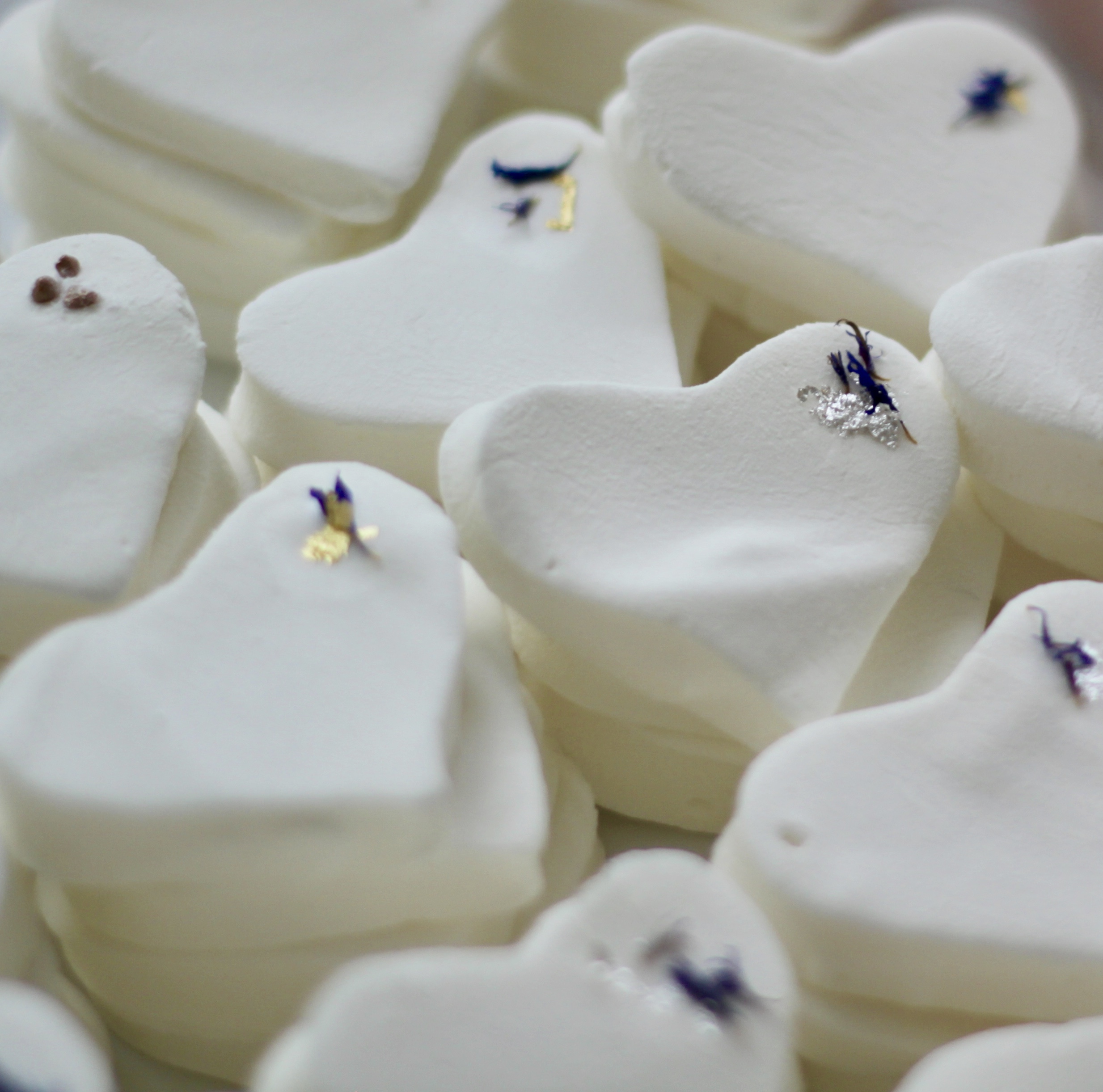 Elderflower marshmallows decorated with gold and silver leaf and blue cornflowers to co-ordinate with bridesmaids’ dresses and wedding colours
