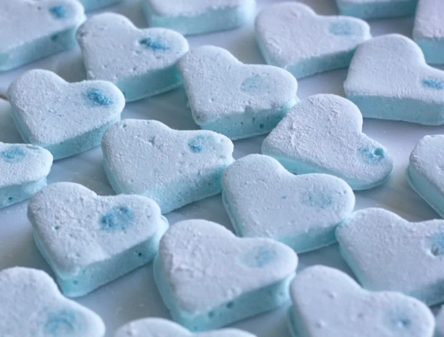 Blue bespoke heart-shaped gin & tonic marshmallows decorated with blue sparkles
