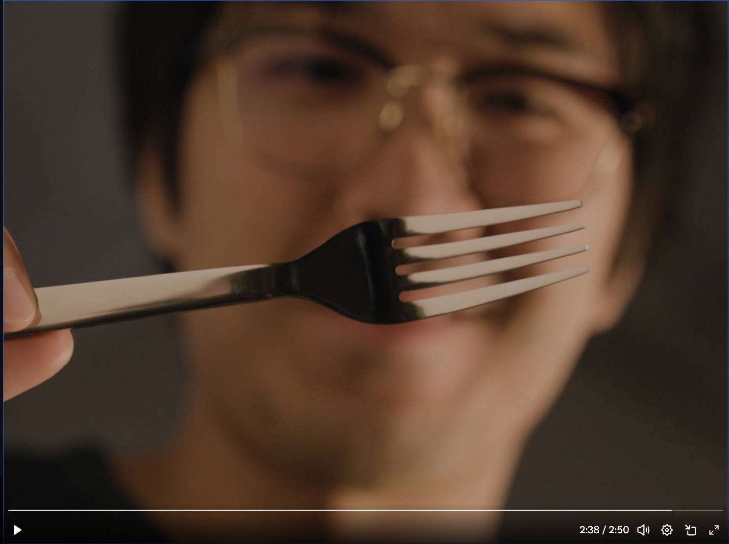 Screenshot of a man holding a fork