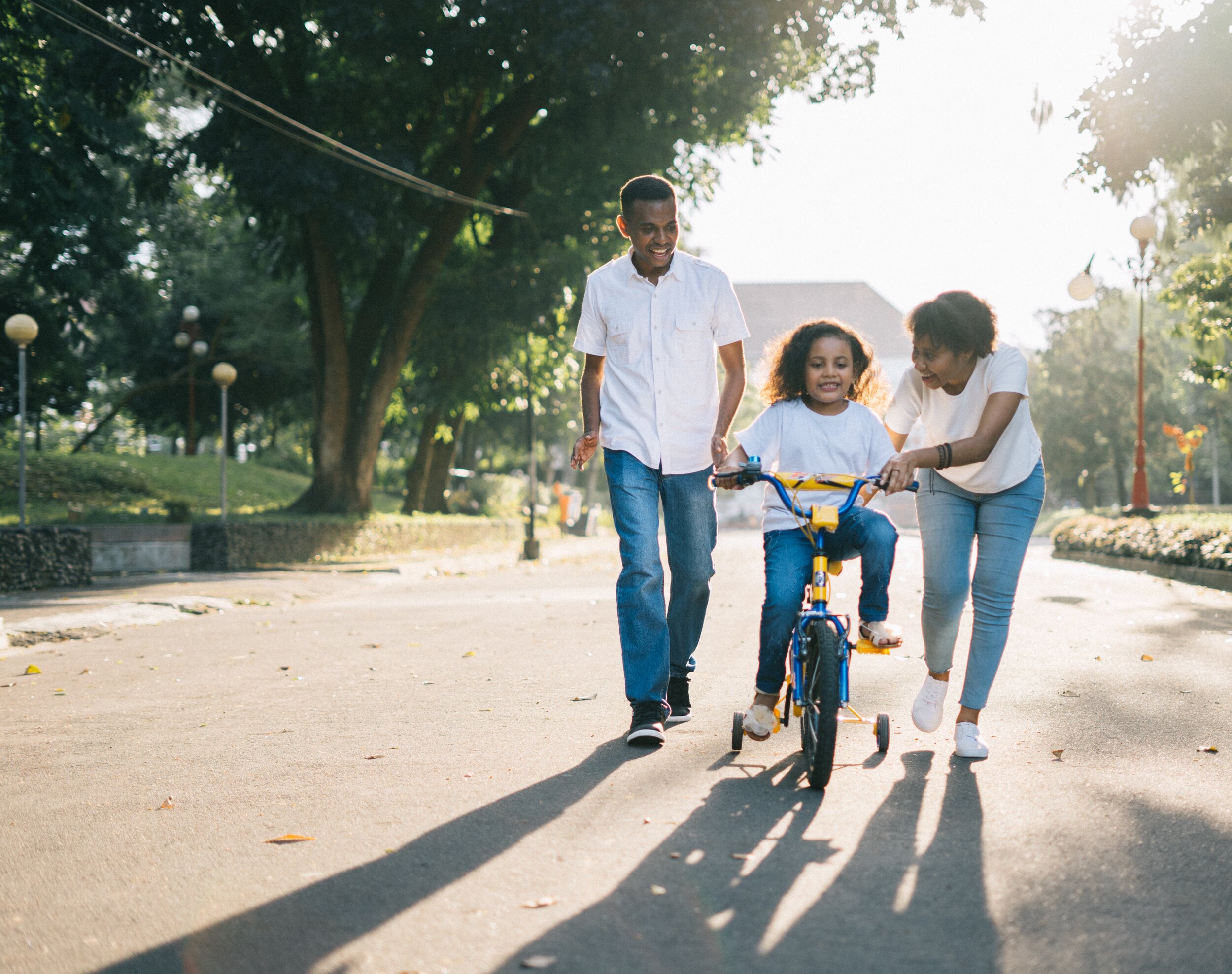 man-standing-beside-his-wife-teaching-their-child-how-to-1128318.jpg