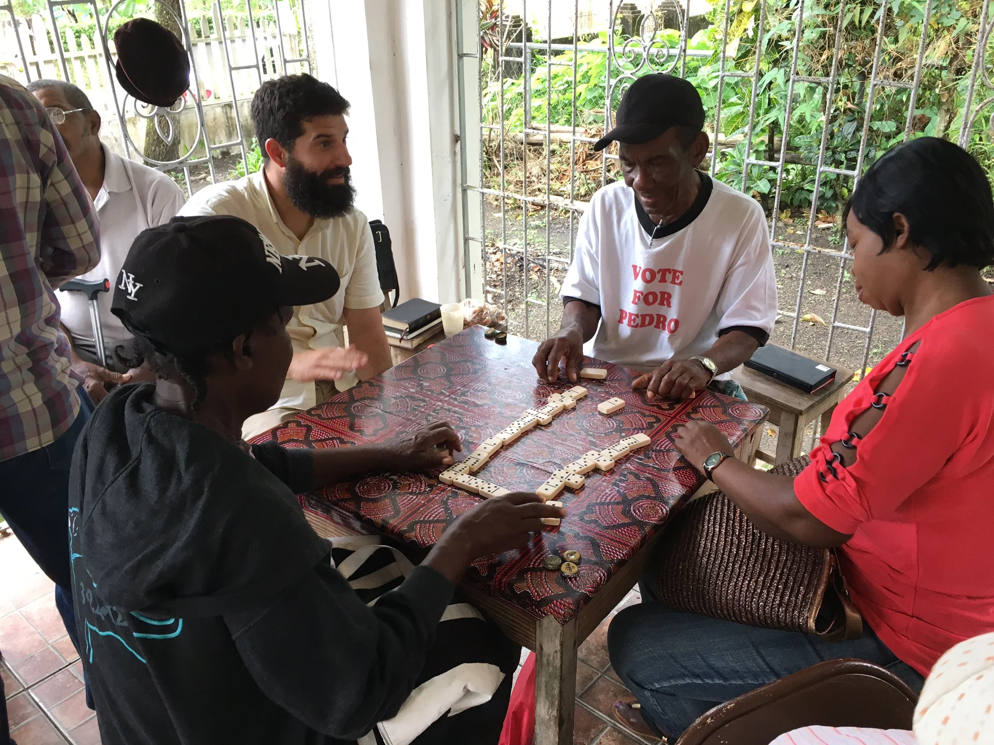 Pastor Jon gets "schooled" in a game of dominoes.