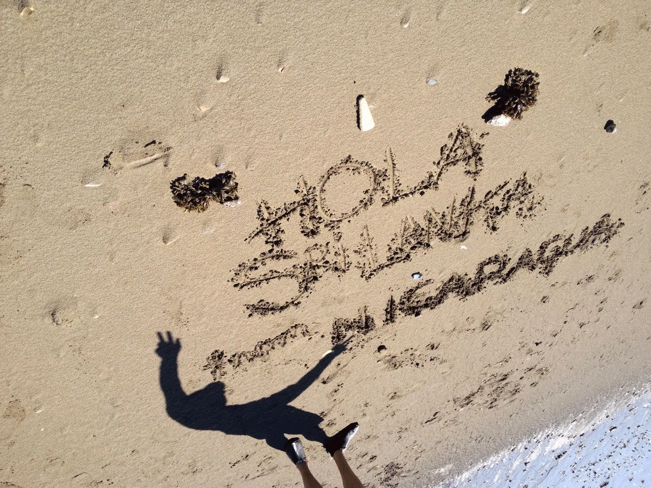Anne writes a message to the citizens of Sri Lanka on a beach in Nicaragua on Sri Lanka's independence day (Feb 4).