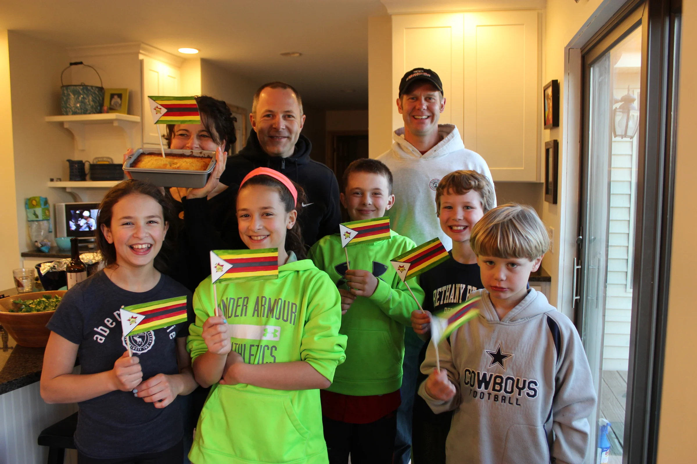 Megan, Chip, Dina, Steve, and their kids host a special dinner on Zimbabwe's independence day (Apr 18). Brian bakes a traditional orange loaf cake.