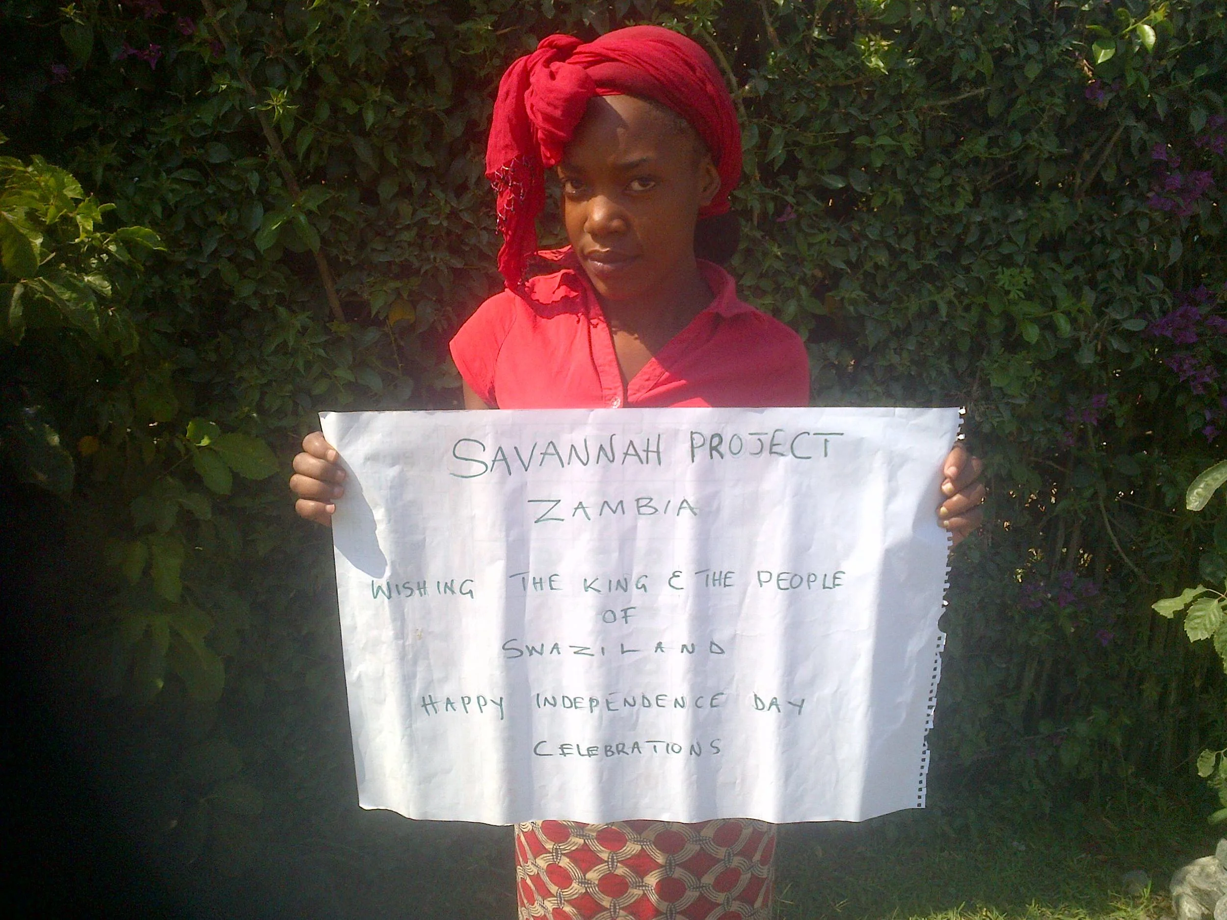 In Zambia, young men and women hold up letters they have written to the King and people of Swaziland.