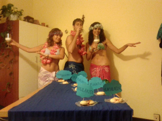 In Italy, Elisabetta, Alice, and friends cook pizzas in the shape of the Tuvalu Islands on Tuvalu's independence day.