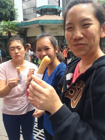 Enjoying a churro filled with caramel. 
