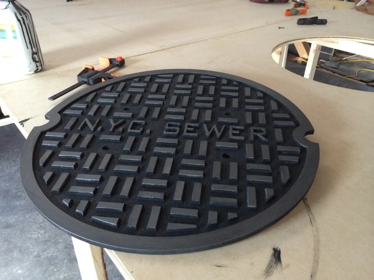 Painted MDF sewer cover replica