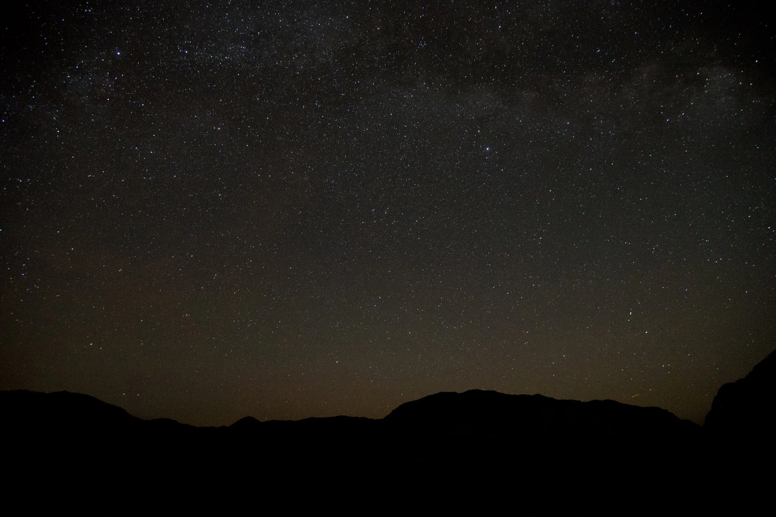 The edge of the milky way galaxy is seen from the top of massive boulders surrounding the Hidden Valley Campground. It is the epicenter of climbing in the Park, where climbers can easily camp together and find partners for the next day. 