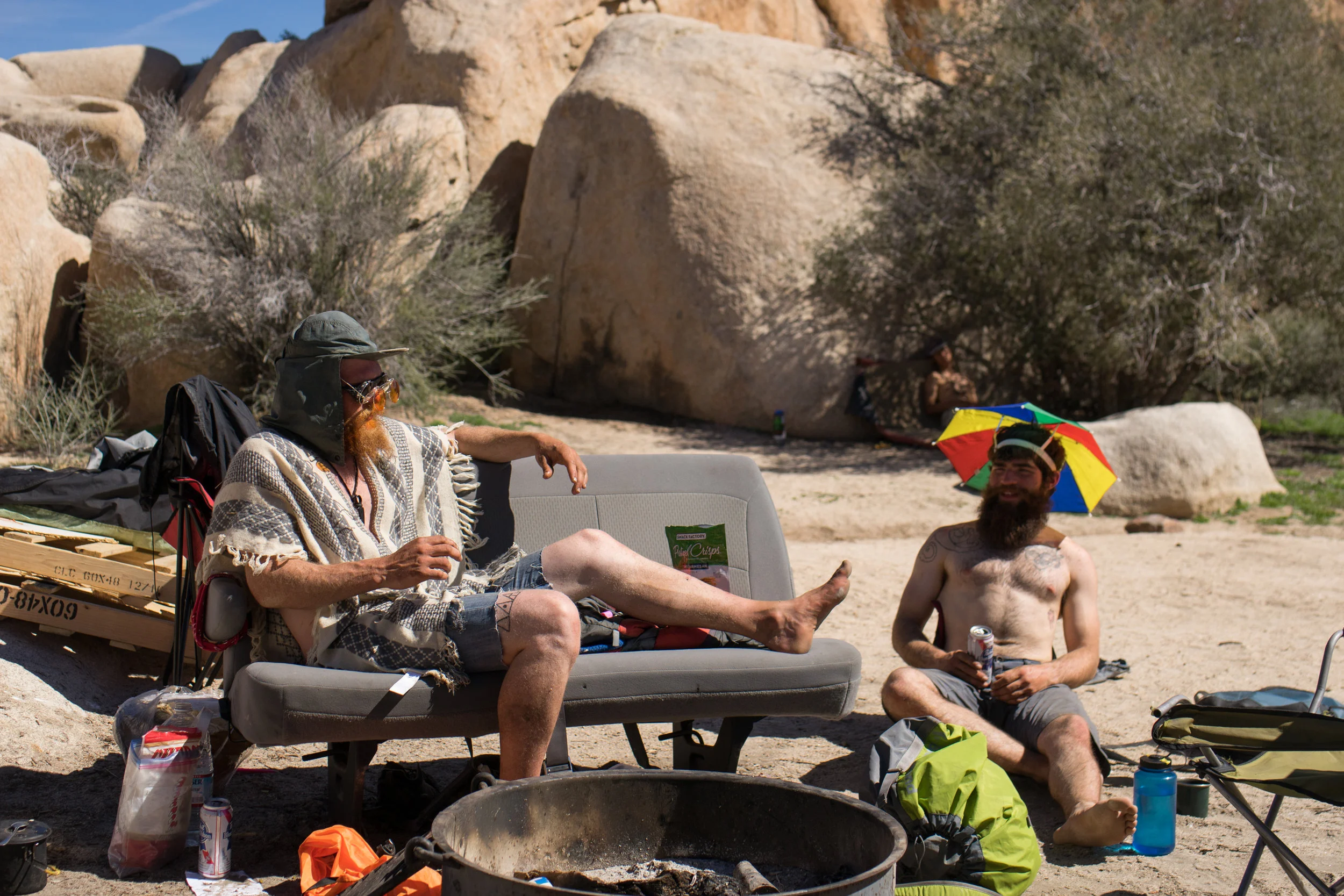 Two climbers at Camp #5 discuss potential routes for the day. Hidden Valley Campground is the place for odd, eccentric, climbers from all walks of life to come and associate with others. They often come to Joshua Tree by themselves, as both these climbers did.