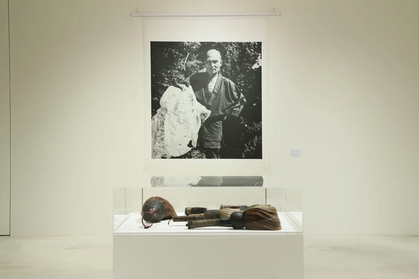 The brushes used by Yu-ichi Inoue, with a photograph of the artist burning works