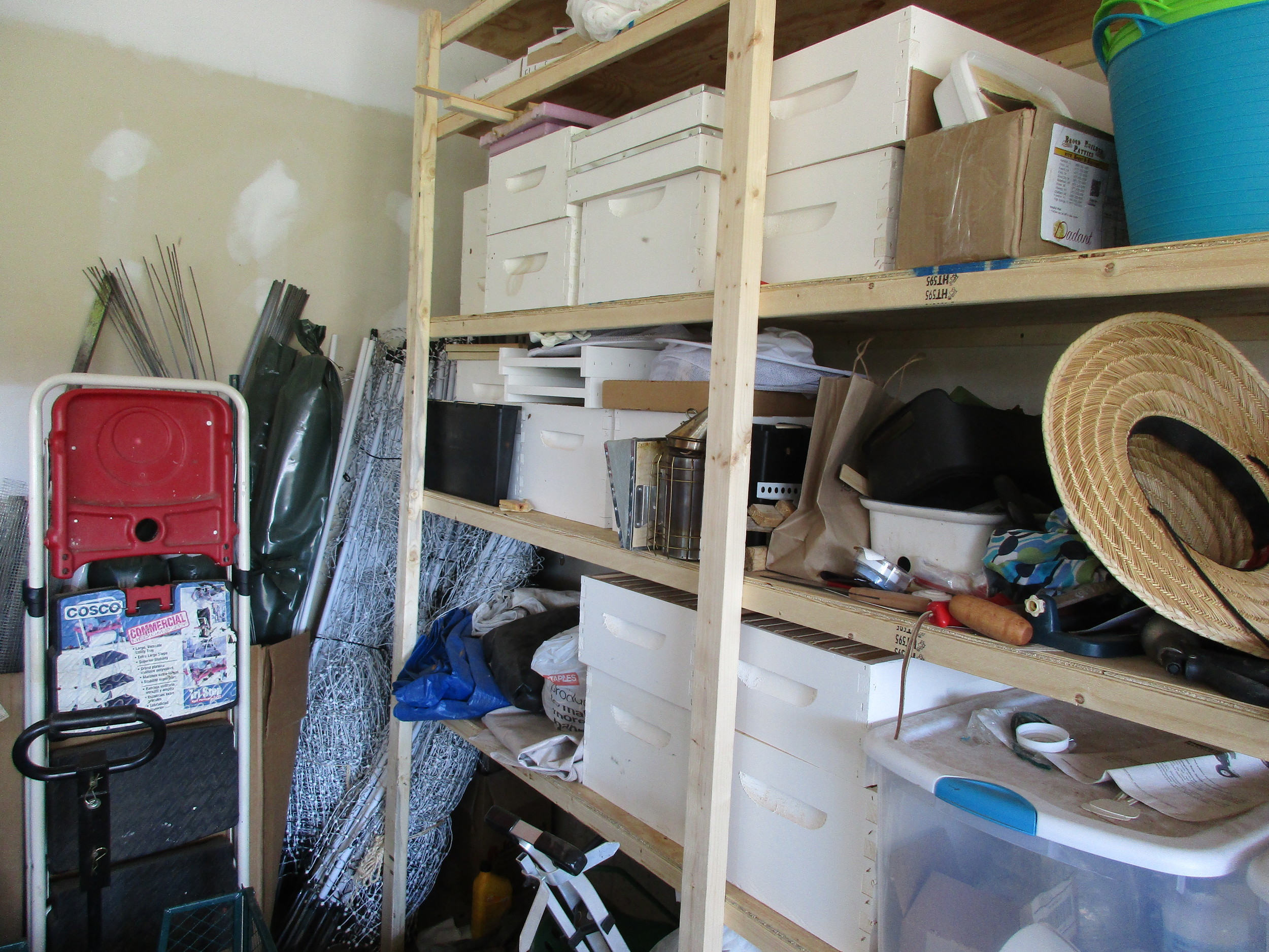 Monday May 9th. I tried to take a picture of the scout bees in our garage, looking for a new home, but they are too small to see. Can you see any?