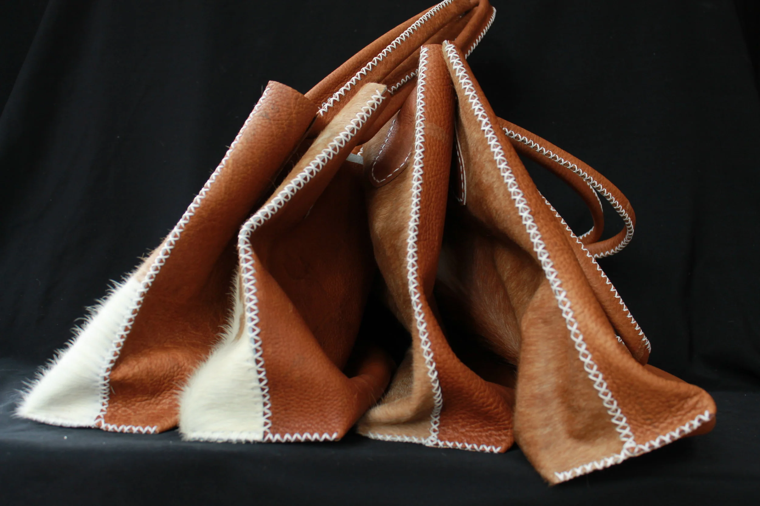 This half and half tote is half bison and half cow hair on hide.
