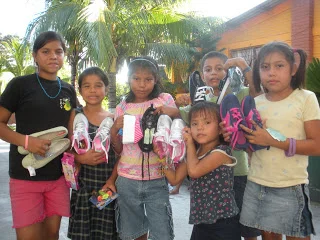 Children at Ciudad de Los Ninos orphanage receiving shoes, candies and other gifts.